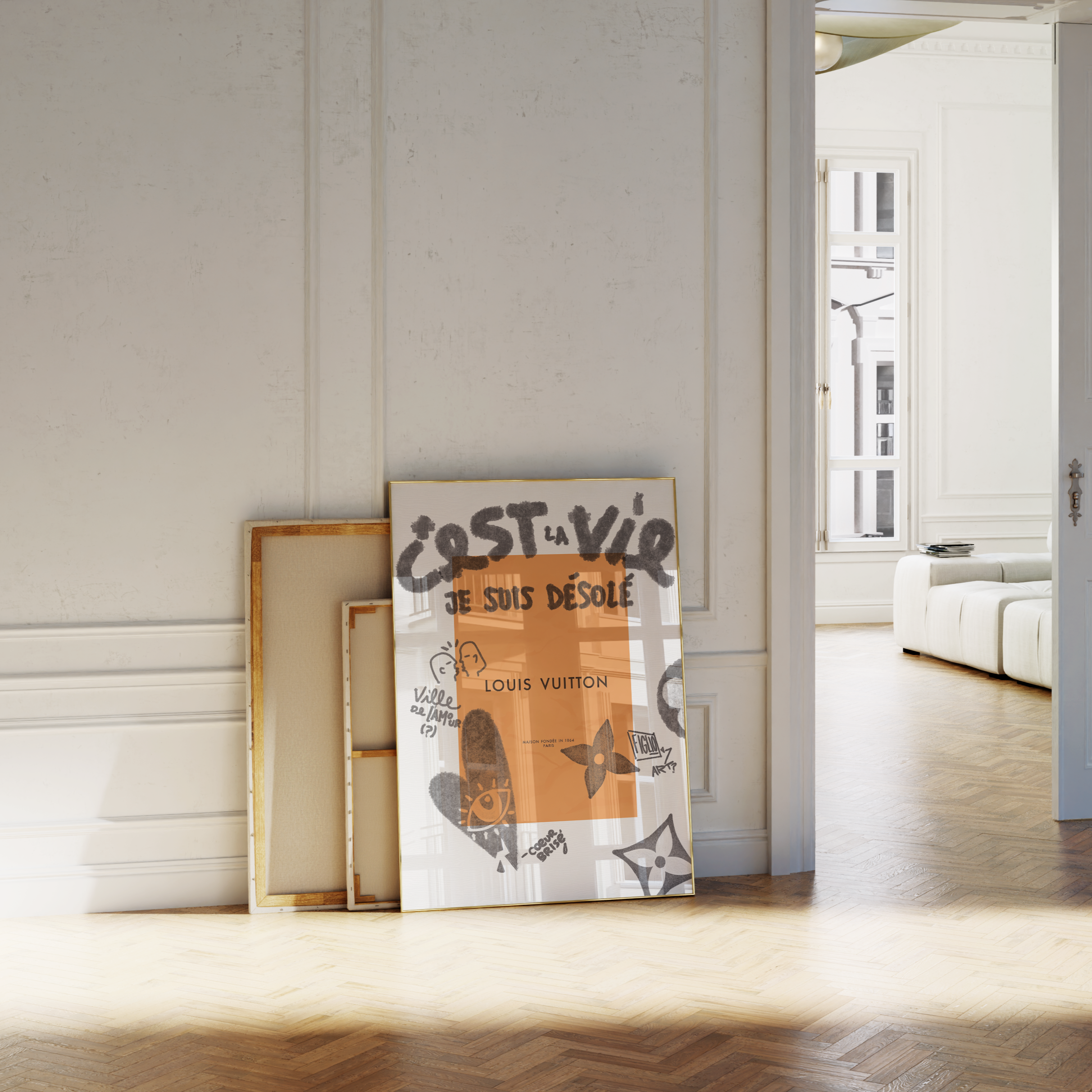 Decorative frames leaning against a white paneled wall in a bright room.